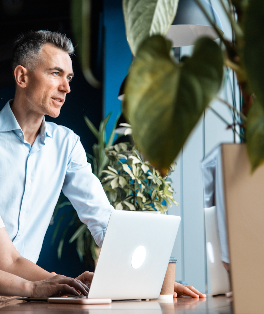 Dirigeant de start-up structurant les bases financières de son entreprise Dirigeant de start-up à Vaud réfléchissant à son budget et plan financier dans un cadre de travail chaleureux